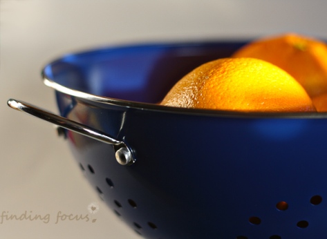 oranges in blue colander kitchen photography